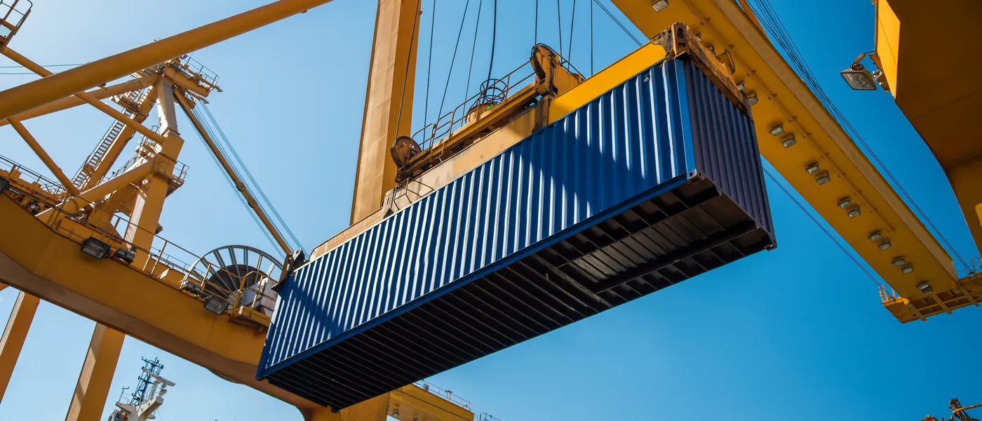 Cargo surveyor supervising container loading at a port terminal