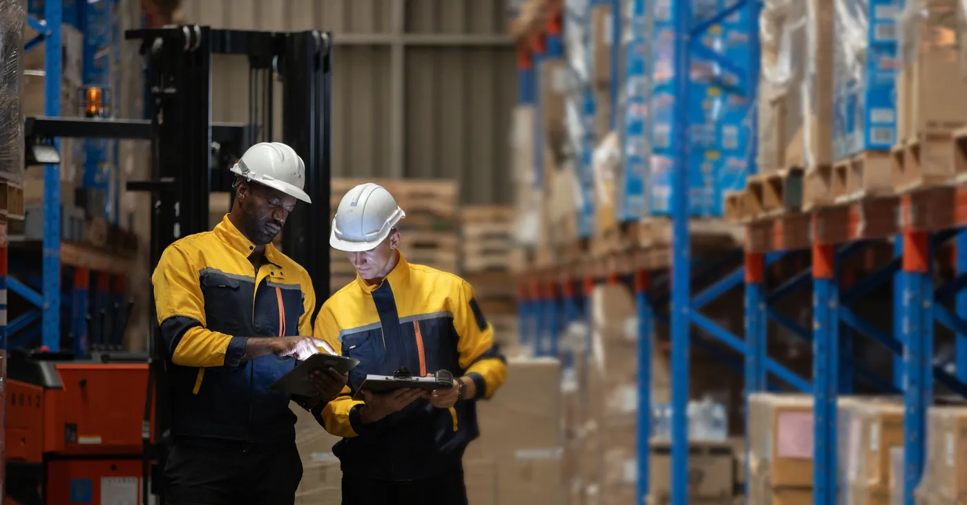 Inspector checking packed goods against the order before shipment