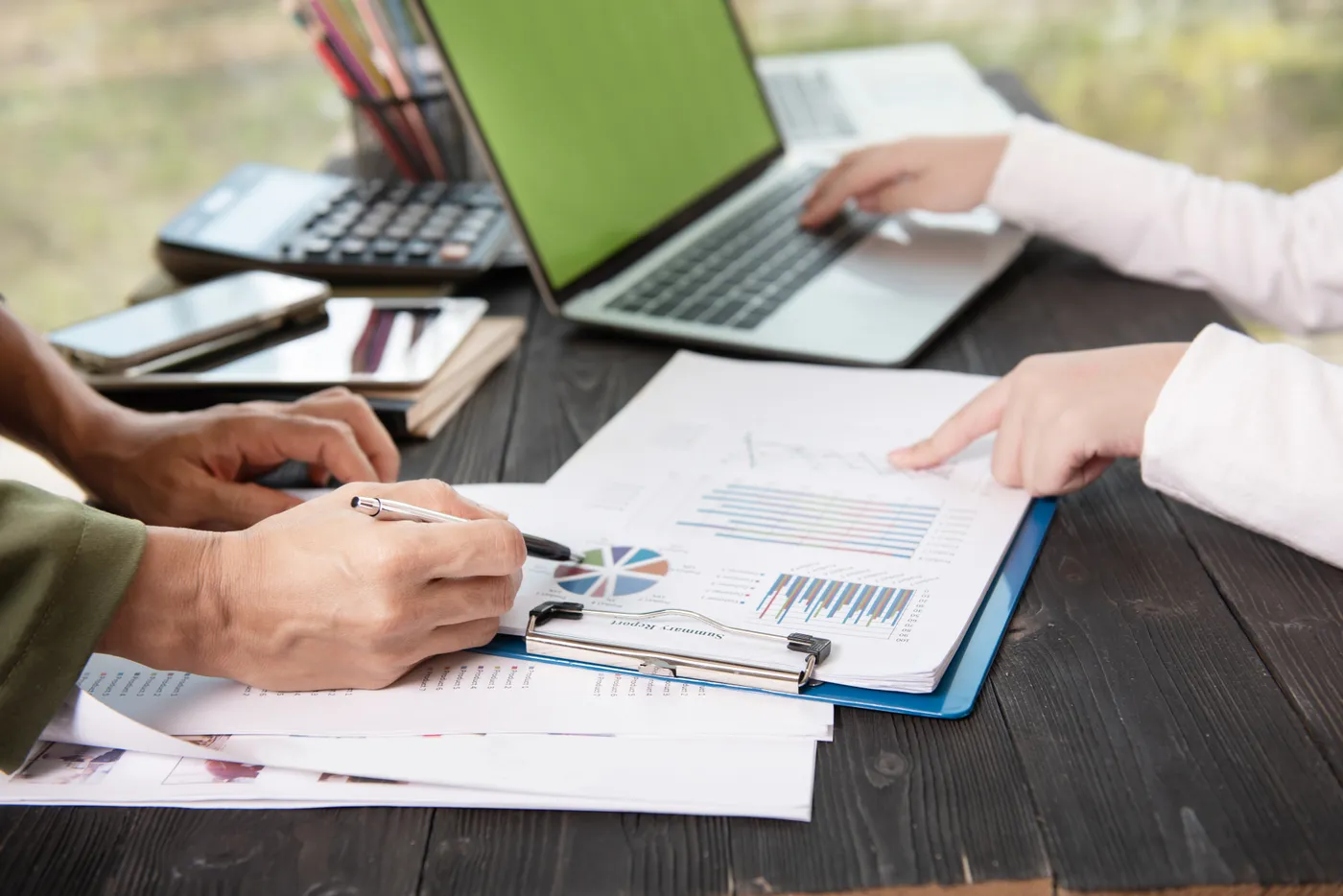 Audit findings reviewed on charts and reports at a supplier's desk