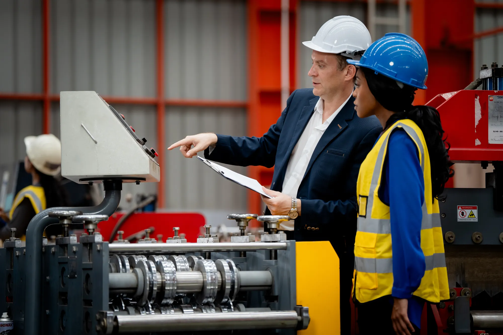 Independent inspector reviewing equipment at a supplier site